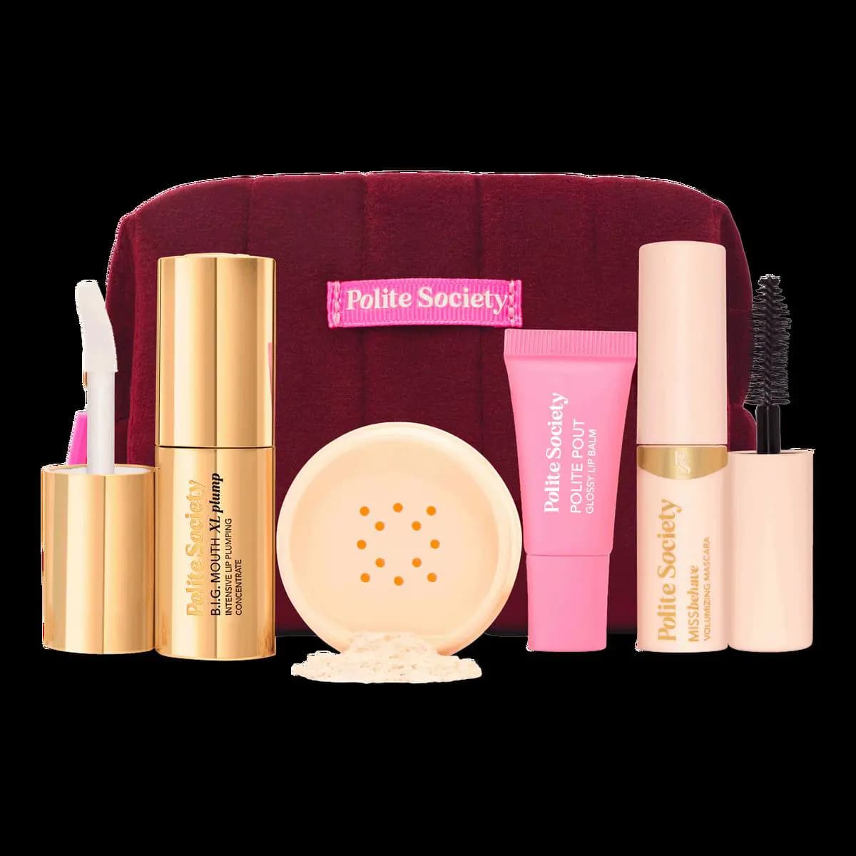 Full contents shot of the 5-piece set with burgundy bag, gold plumper, powder jar, pink lip balm tube and cream mascara
