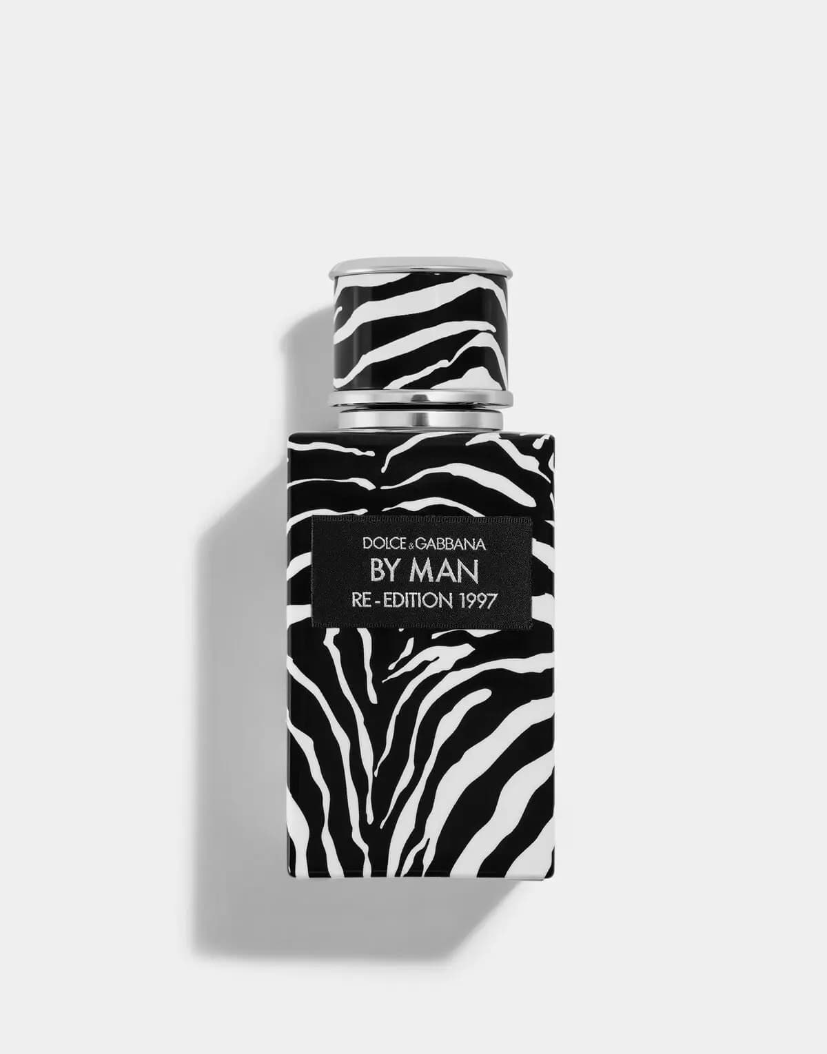 By Man Re-Edition bottle in zebra print with a silver collar and black label on a white background