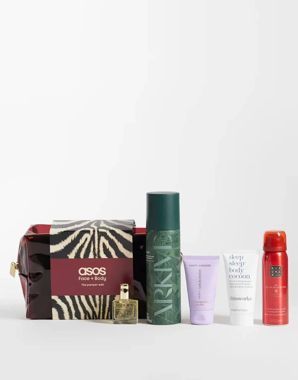 ASOS Pamper edit with zebra sleeve, NUXE oil, green Arkive dry shampoo, Happy Endings balm, This Works and Rituals gel