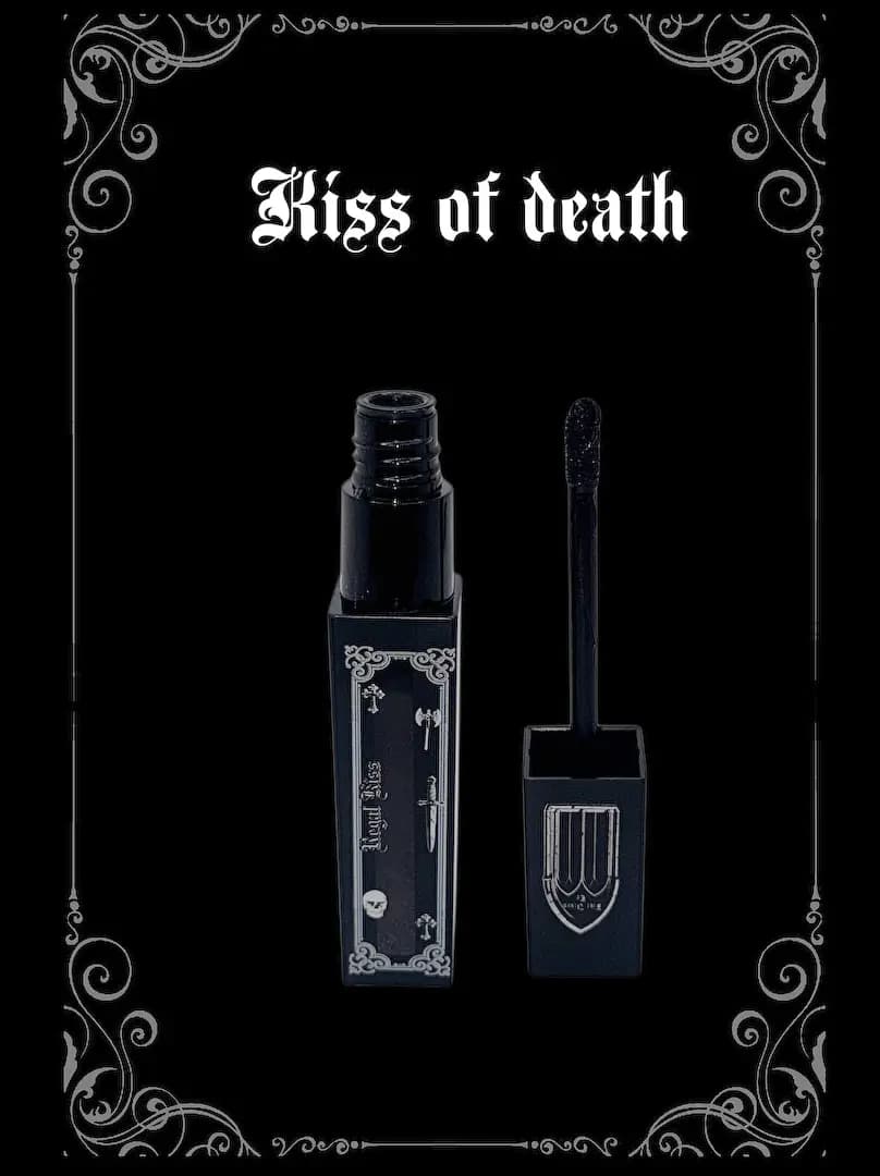Kiss of death tube open with its black-tipped wand on a black background with silver scroll corners.