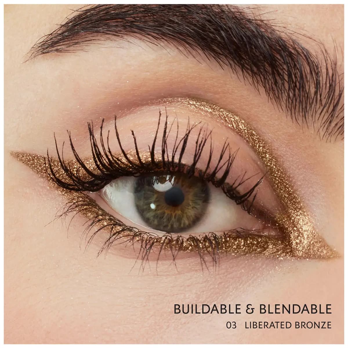 Green eye with sparkling bronze graphic winged liner, captioned "Buildable & blendable, 03 Liberated Bronze.