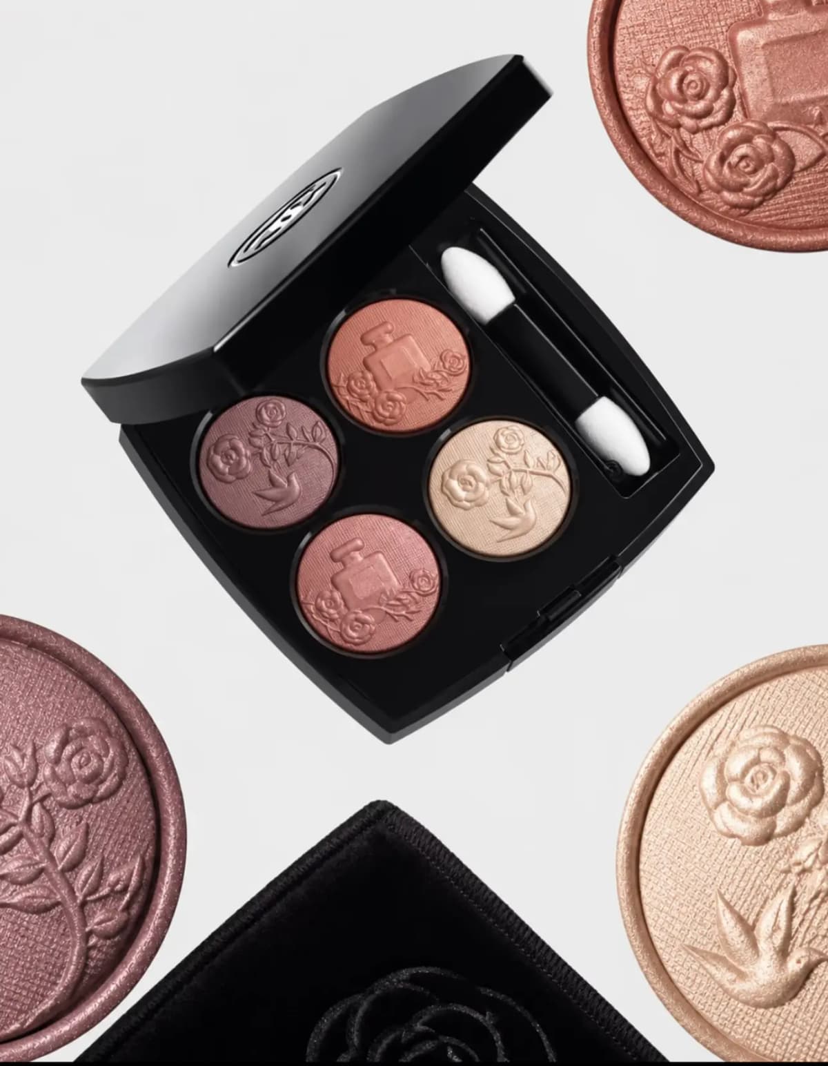 Open Chanel quad compact featuring mauve, terracotta rose, champagne and peach shimmer eyeshadows with floral embossing.