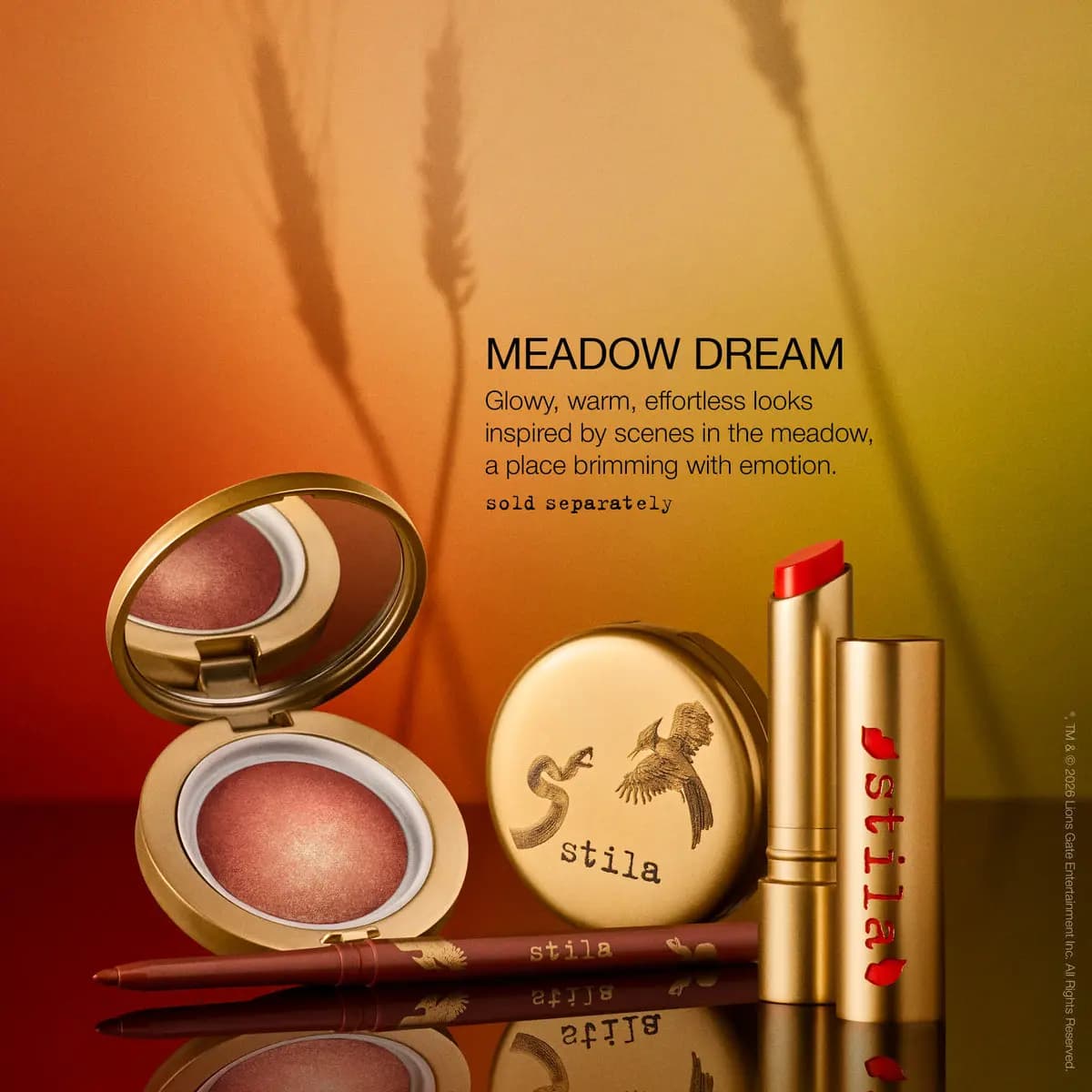 Meadow Dream look: rosy baked compact, gold eye shadow compact, coral lipstick and brown pencil on an orange backdrop