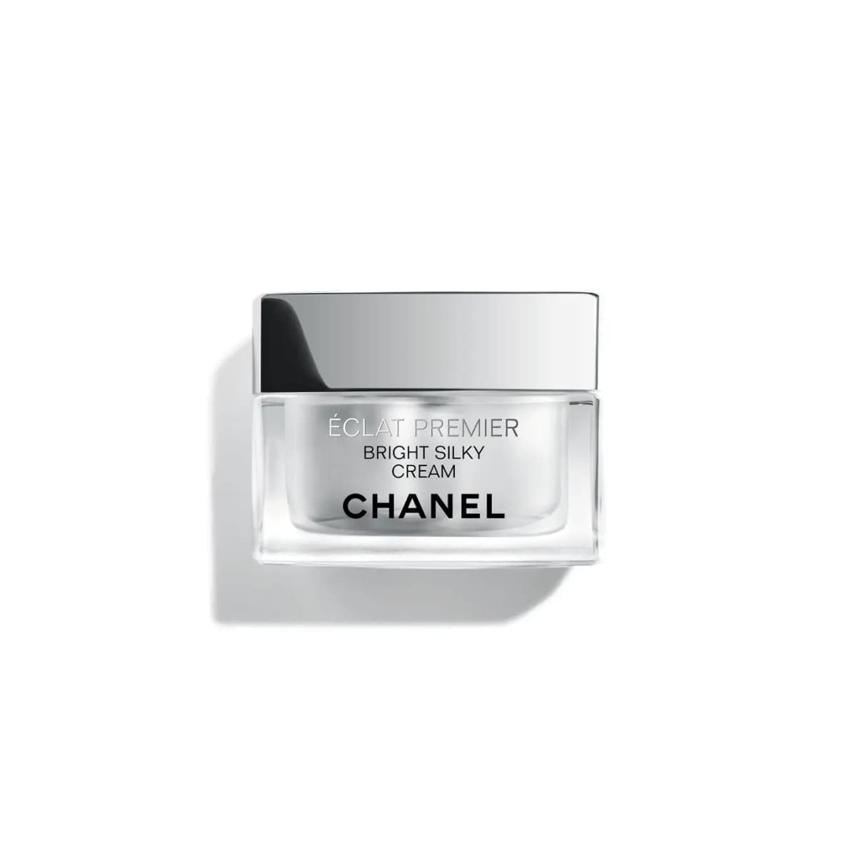 CHANEL Éclat Premier Bright Silky Cream in a clear glass jar with a mirrored silver square lid on a white background