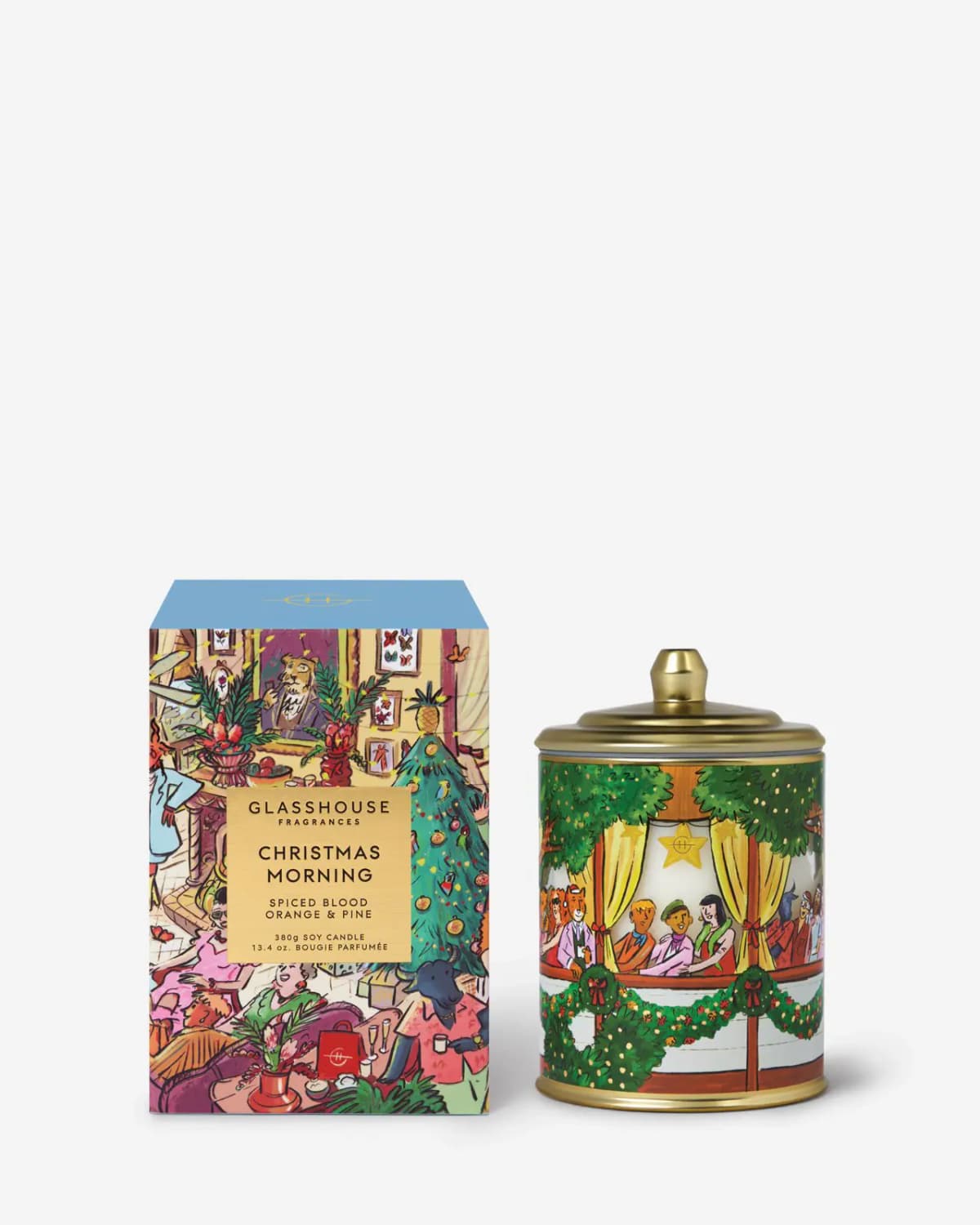 Christmas Morning candle with gold lid and balcony party scene beside its light-blue-topped box on white