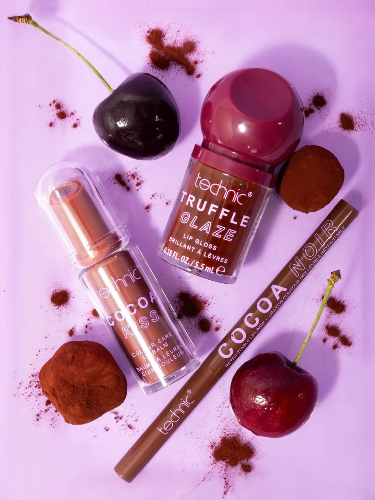 Truffle Glaze gloss, Cocoa Kiss balm and Cocoa Noir lip liner among cherries, cocoa truffles and dusted cocoa powder