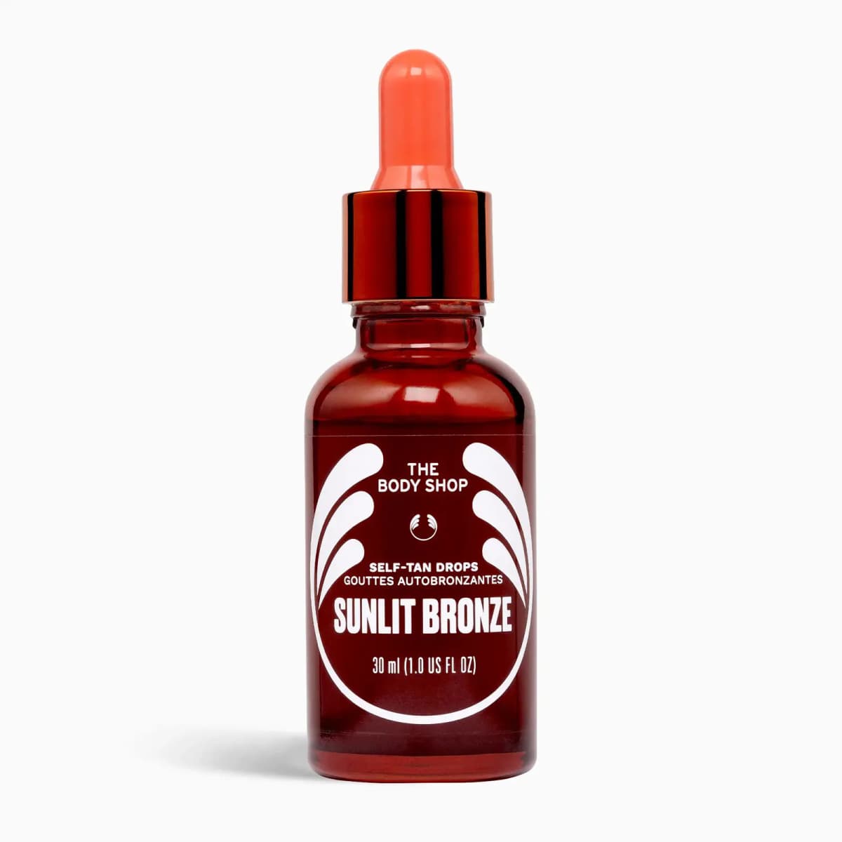 Sunlit Bronze self-tan drops in a red glass dropper bottle with coral pipette, 30ml
