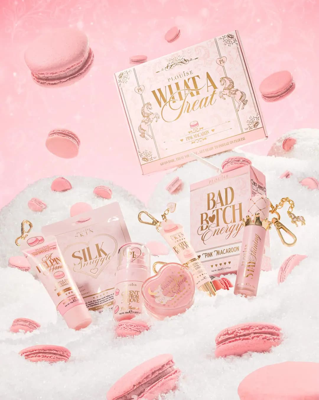 What A Treat Pink Macaron box with Silk Snuggle mask, hand cream, lip gloss and Bad Bitch Energy among macarons