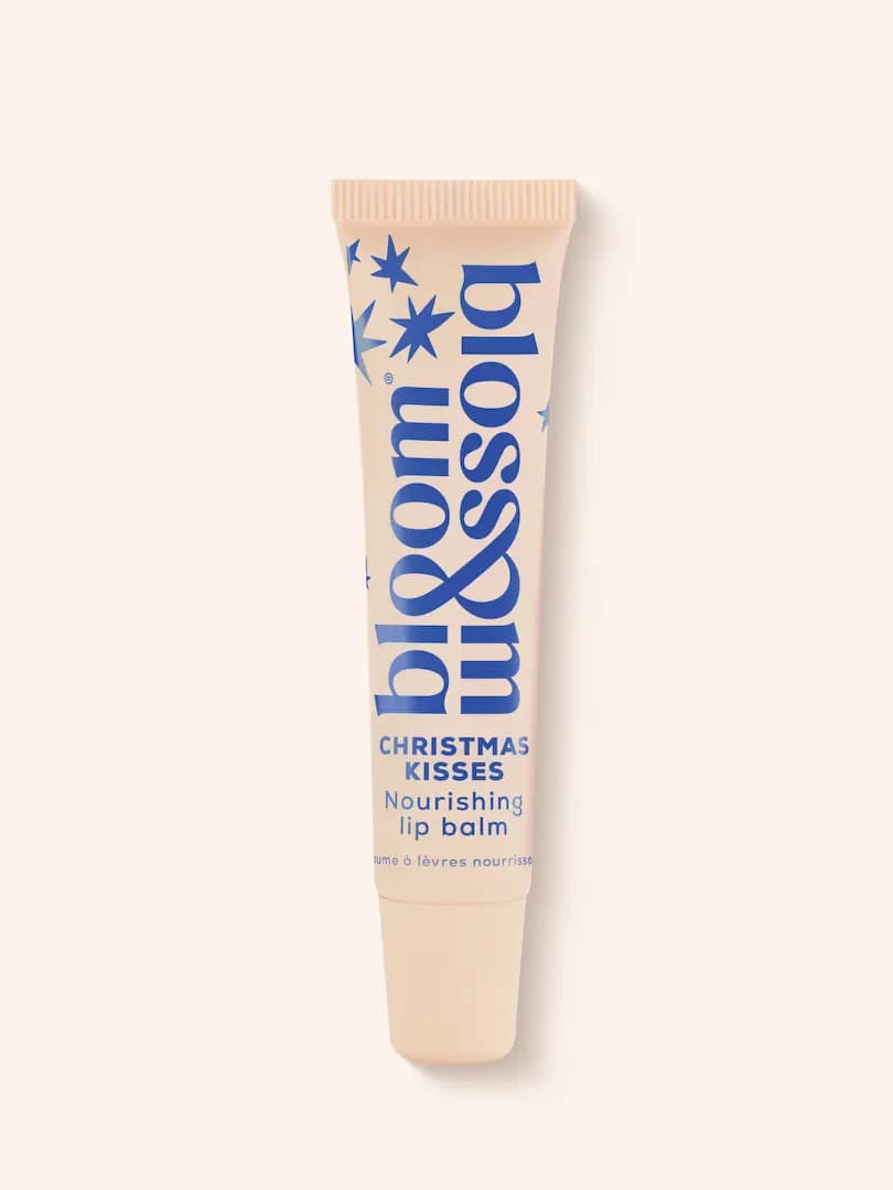 Peach Bloom & Blossom Christmas Kisses Nourishing lip balm tube with blue lettering and stars