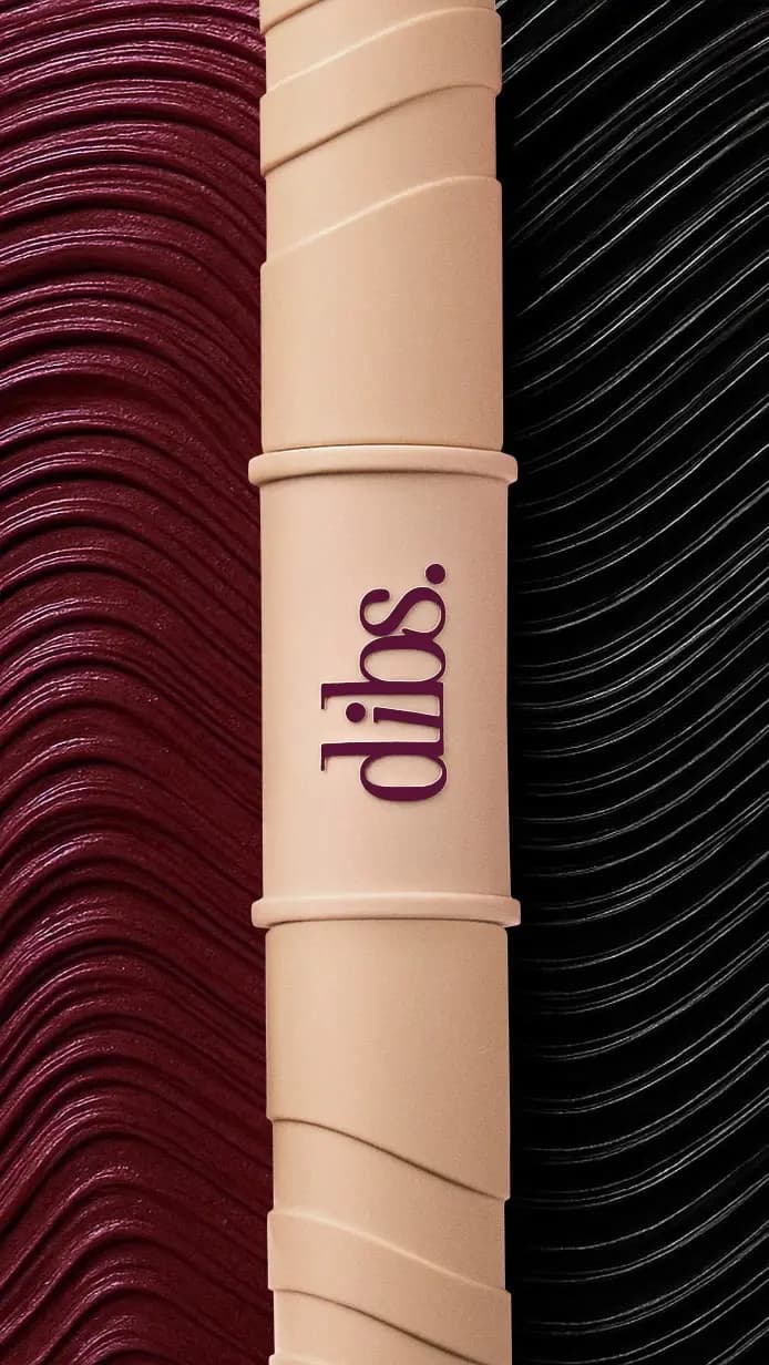 DIBS Beauty Burgundy Double Standard Primer & Mascara Duo tube in beige between burgundy and black mascara swatches