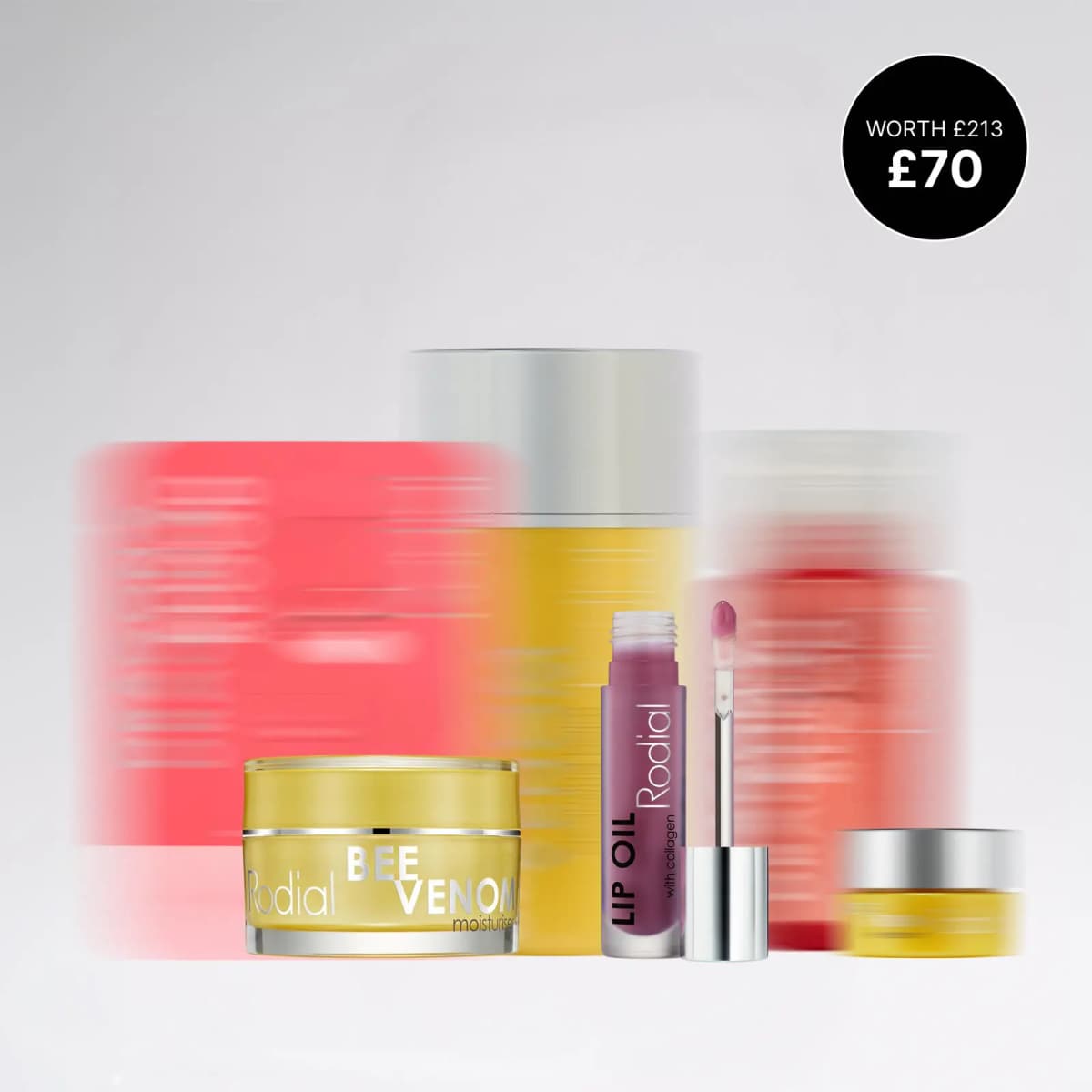 Bee Venom Moisturiser and Lip Oil in front of blurred red and yellow Rodial products, with a £70 worth £213 badge