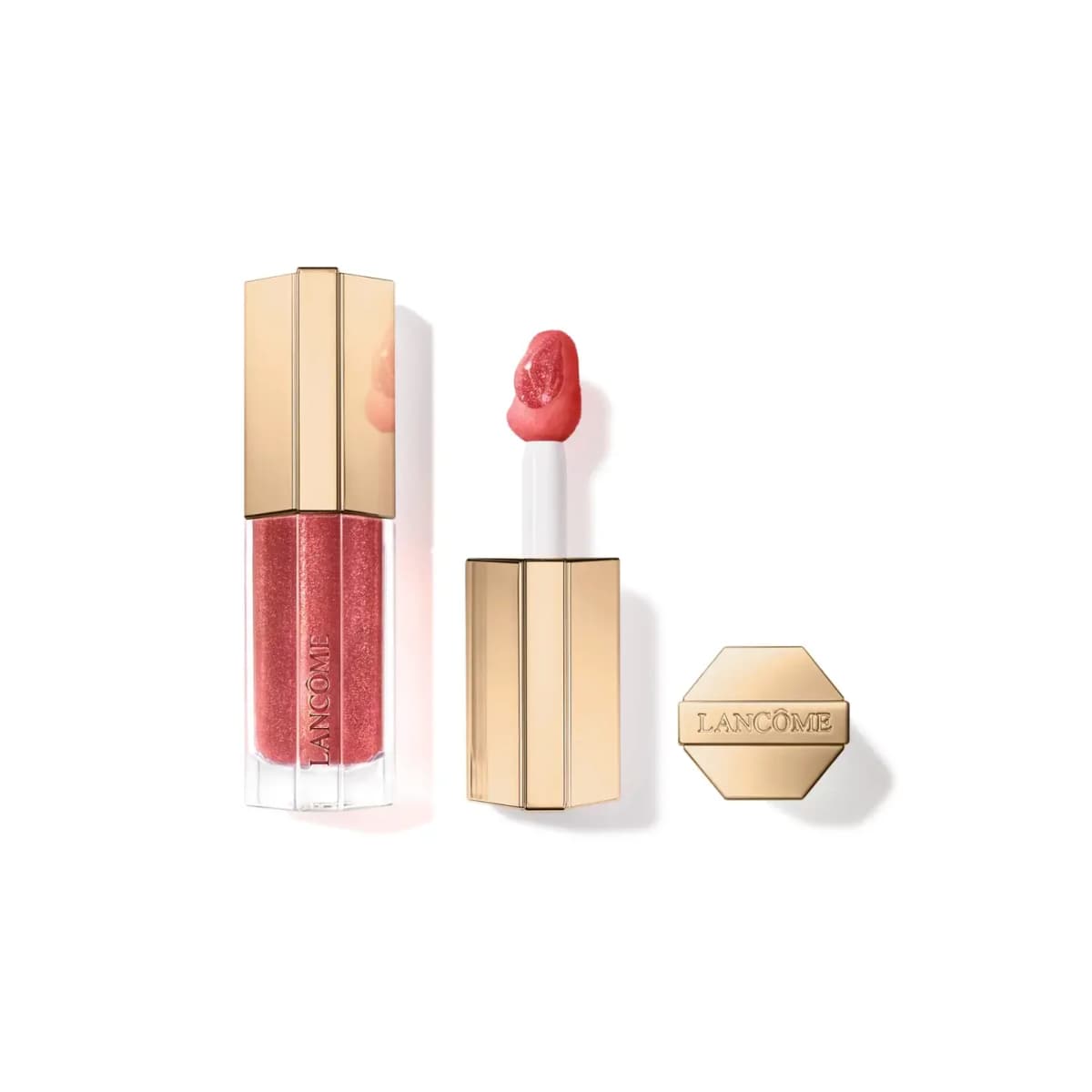 Lancôme lip oil gloss in shimmering berry-coral with a hexagonal gold cap, open doe-foot applicator and gold top