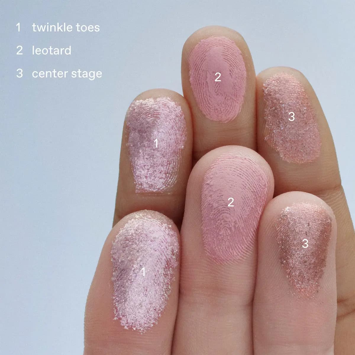 Three fingertips swatched with twinkle toes iridescent pink shimmer, leotard dusty pink matte, and center stage rose shimmer.