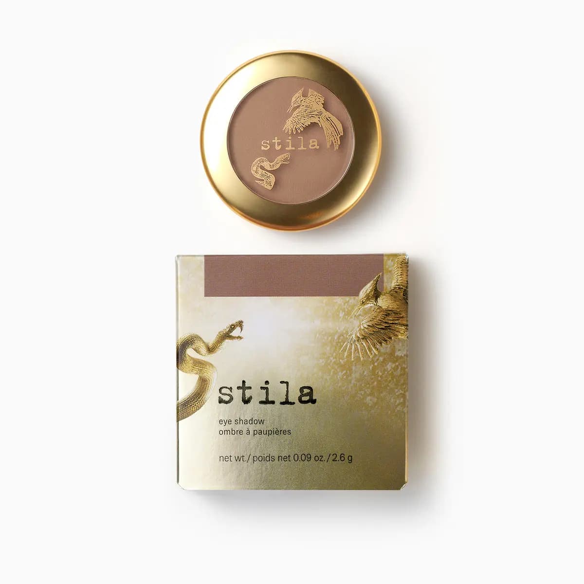 Matte taupe eye shadow in a round gold compact with gold bird and snake print, above its gold box