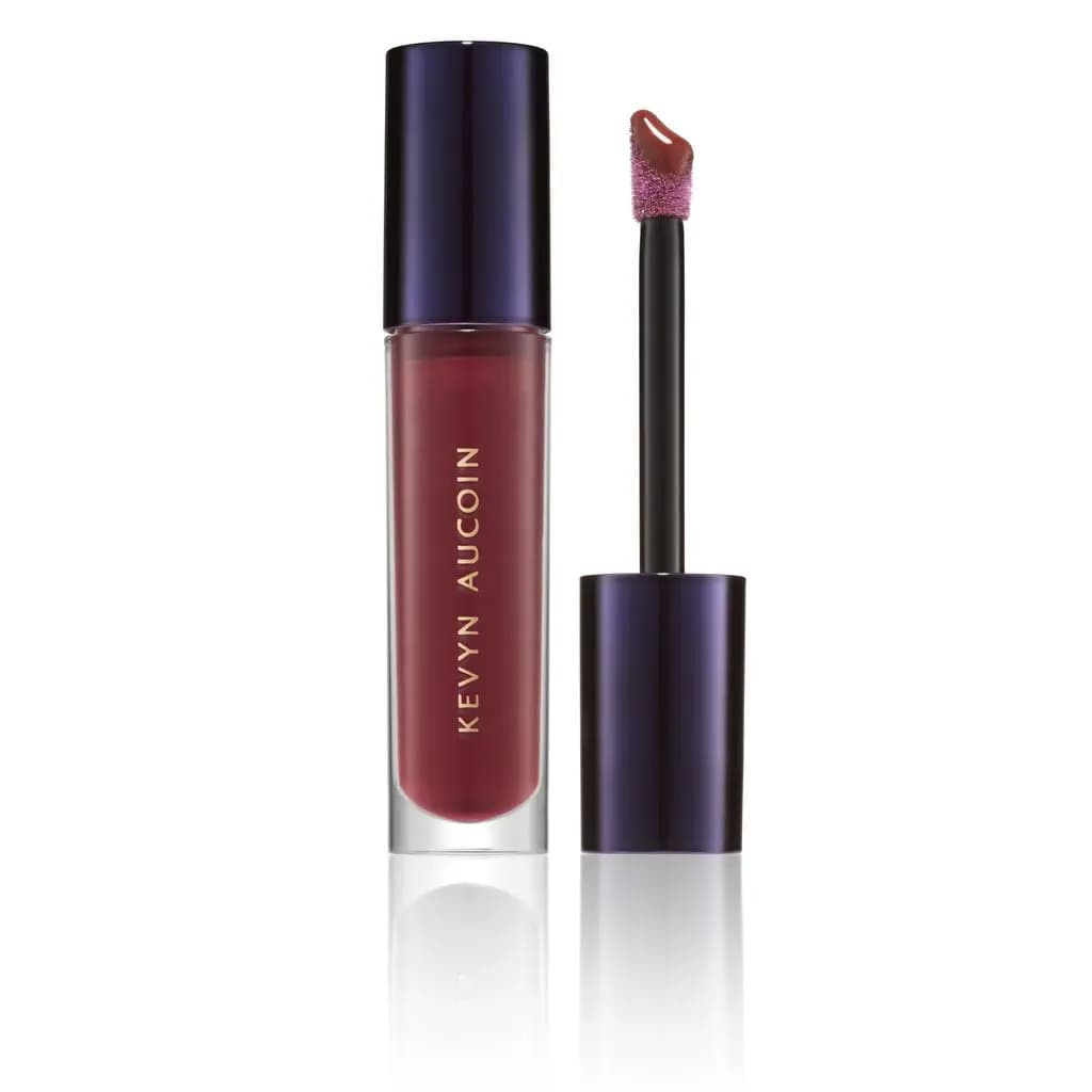 Celestial Lip Gloss tube with navy cap off, showing a doe-foot applicator coated in deep red gloss