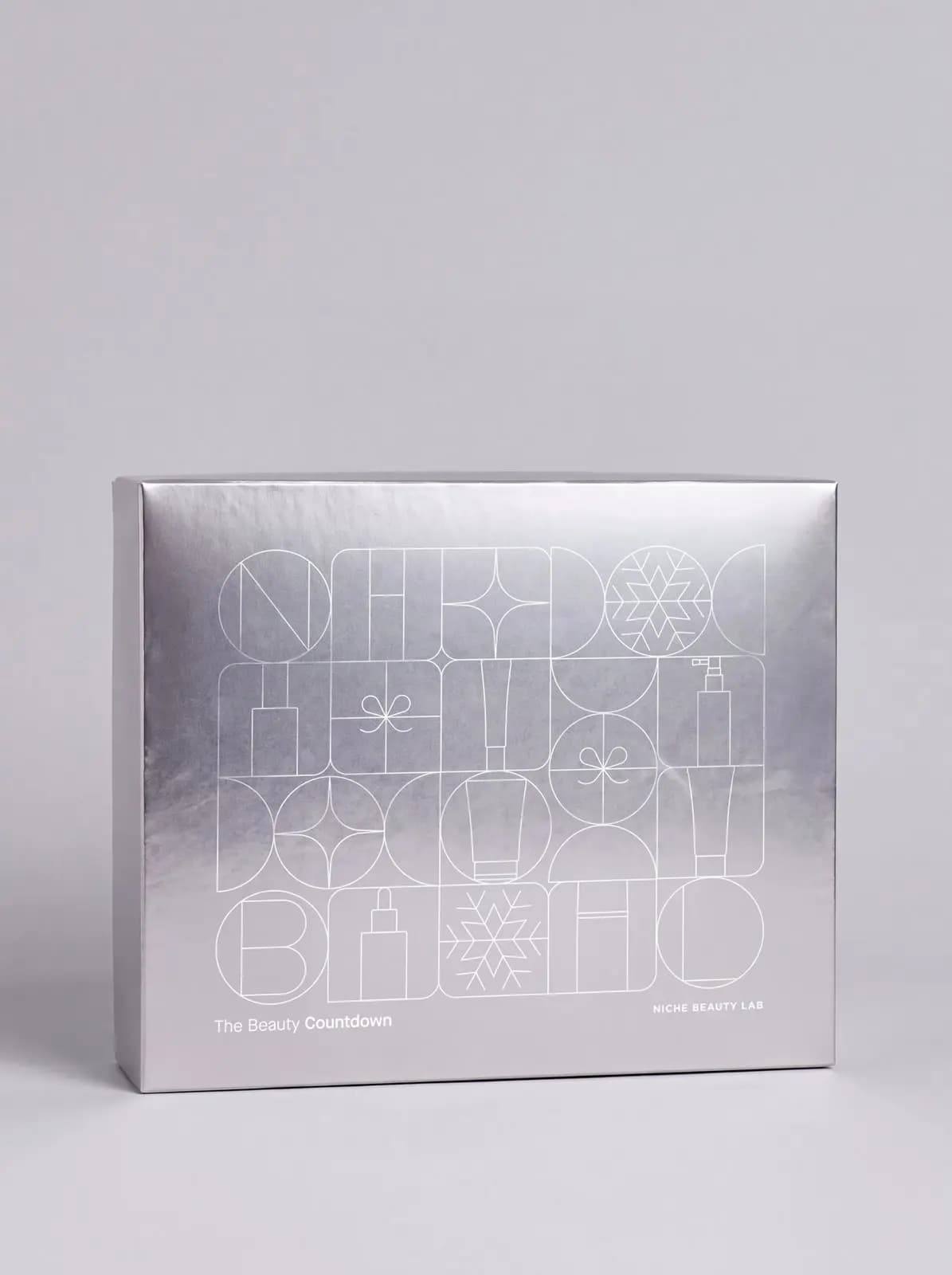 Silver metallic advent calendar box with line-drawn beauty product illustrations