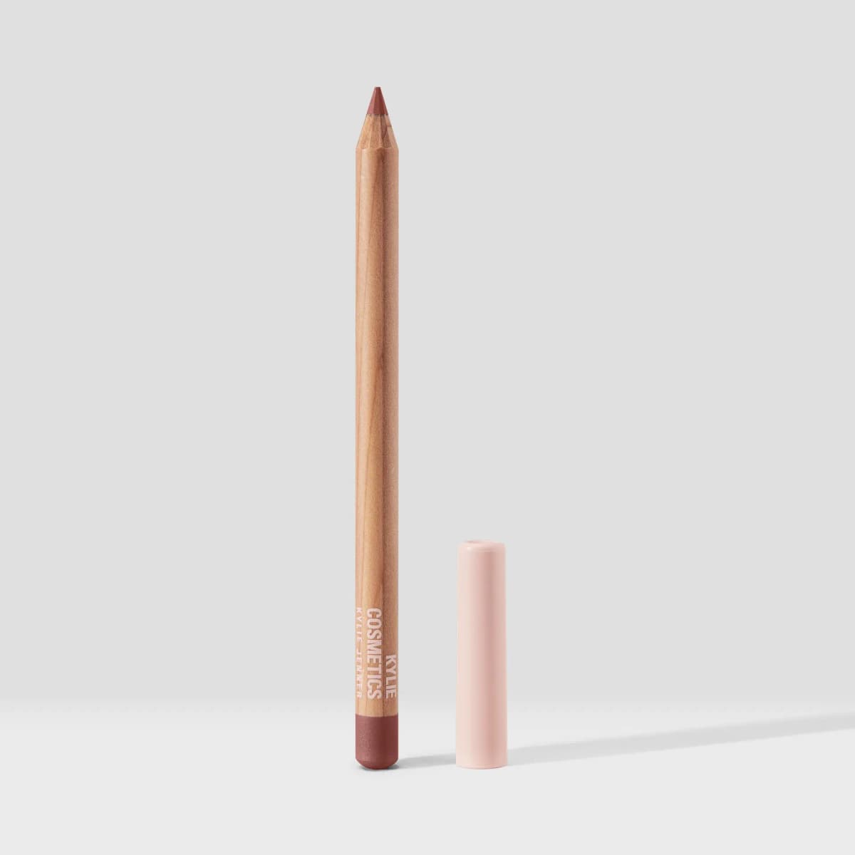 Kylie Cosmetics wooden lip pencil by Kylie Jenner with pink cap and mauve-nude tip.