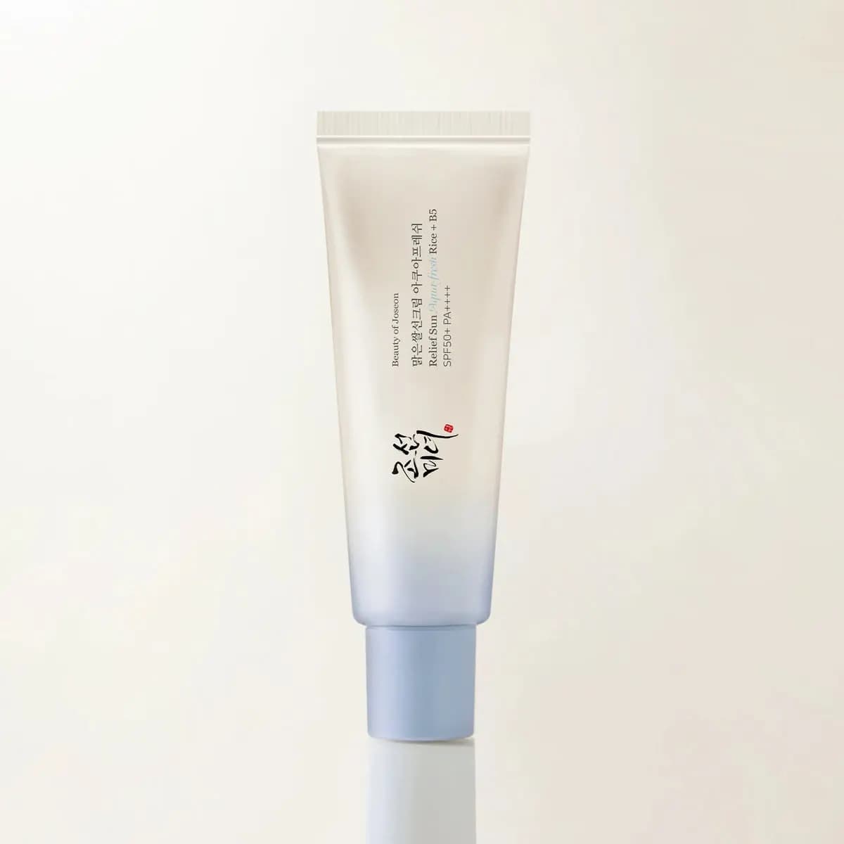 Relief Sun Aqua-fresh Rice + B5 SPF50+ PA++++ tube fading from cream to pale blue against a cream backdrop