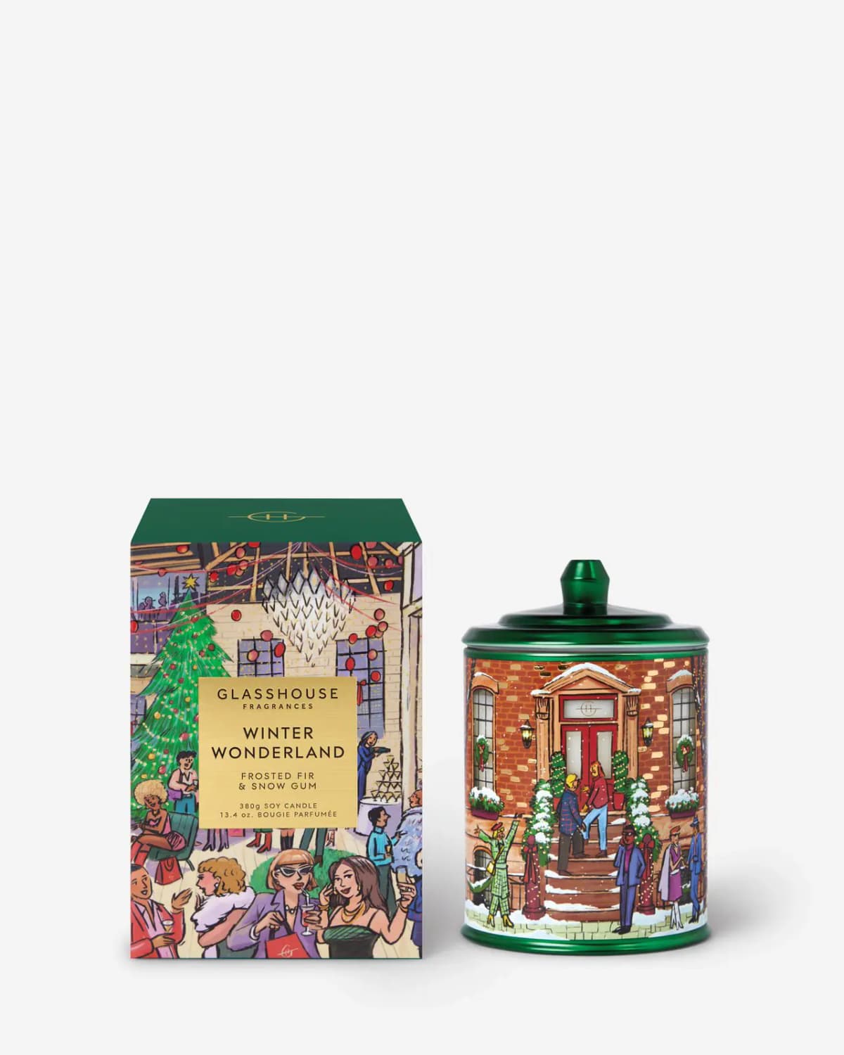 Winter Wonderland candle with green lid and brownstone tin beside its dark-green-topped party box on white