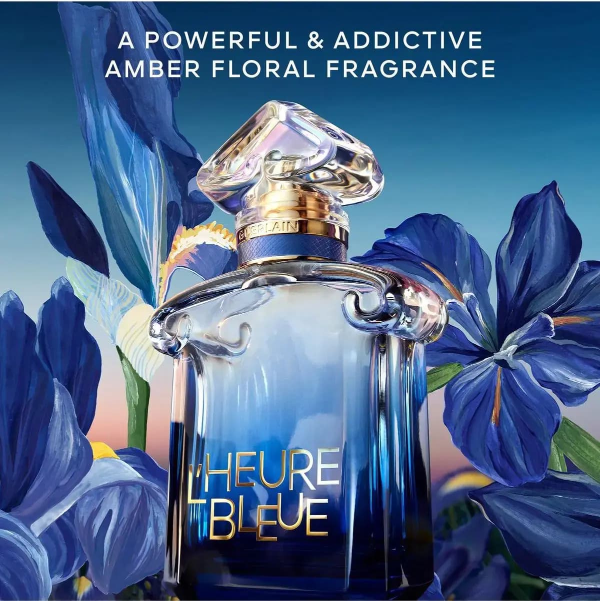 L'Heure Bleue bottle among painted blue irises under twilight sky with text: a powerful & addictive amber floral fragrance.