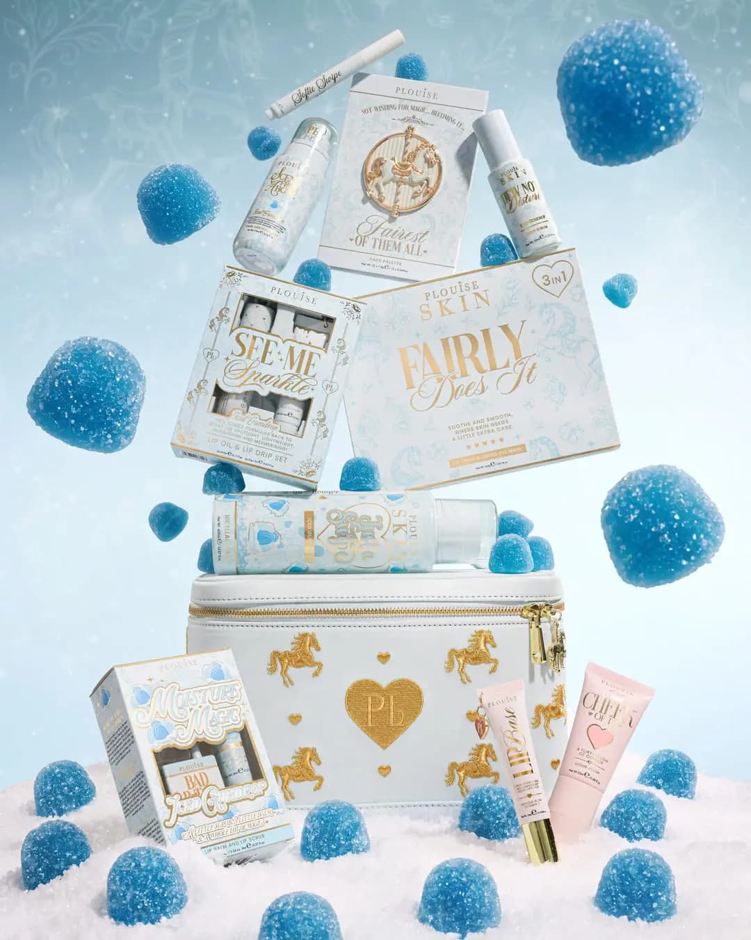 Blue Iced Gumdrop products stacked on a white vanity case, including Fairly Does It, See Me Sparkle and Moisture Magic
