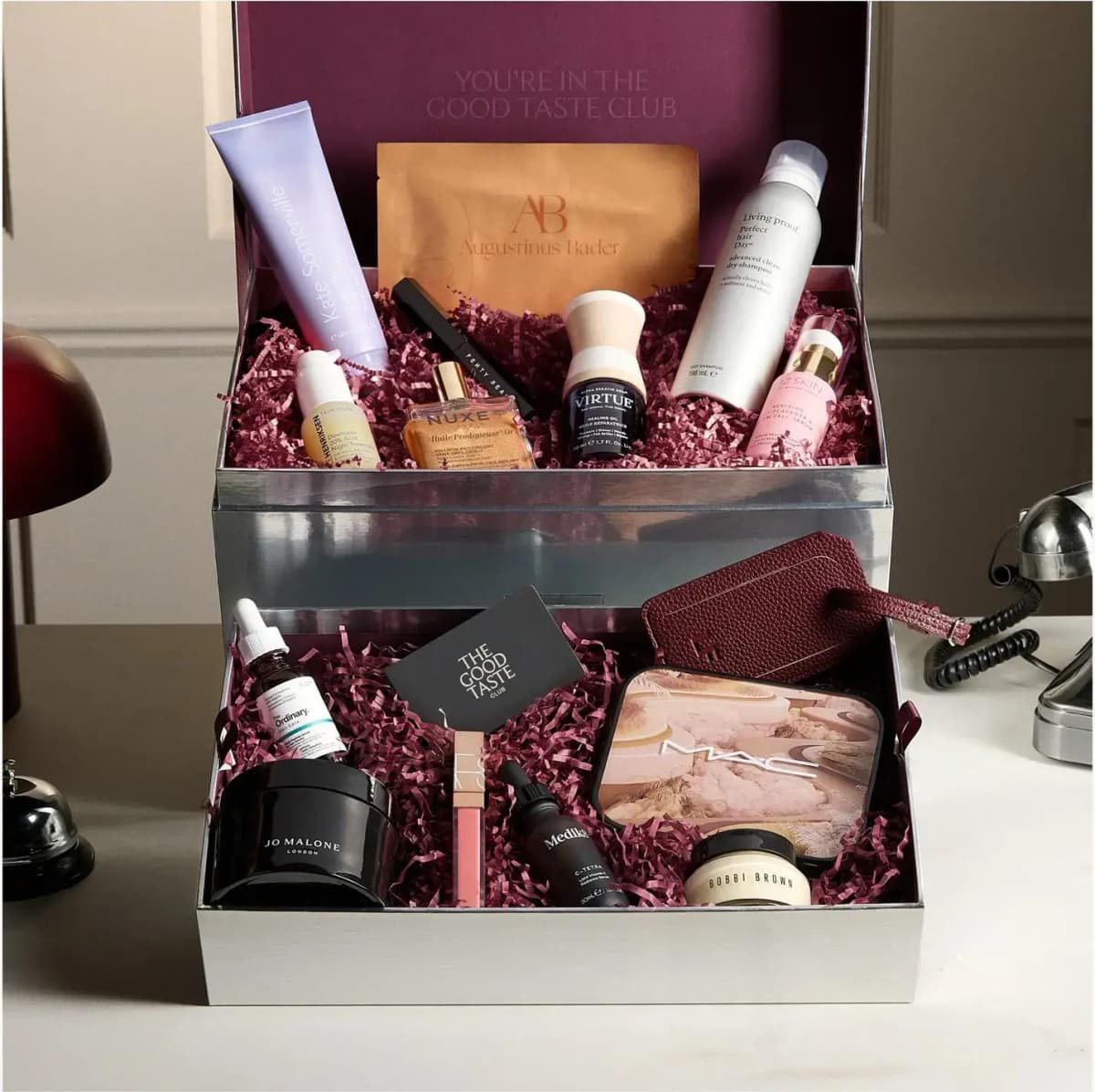 LOOKFANTASTIC Beauty Vault 2026 beauty box, two tiers of skincare and makeup in burgundy shred inside a silver trunk