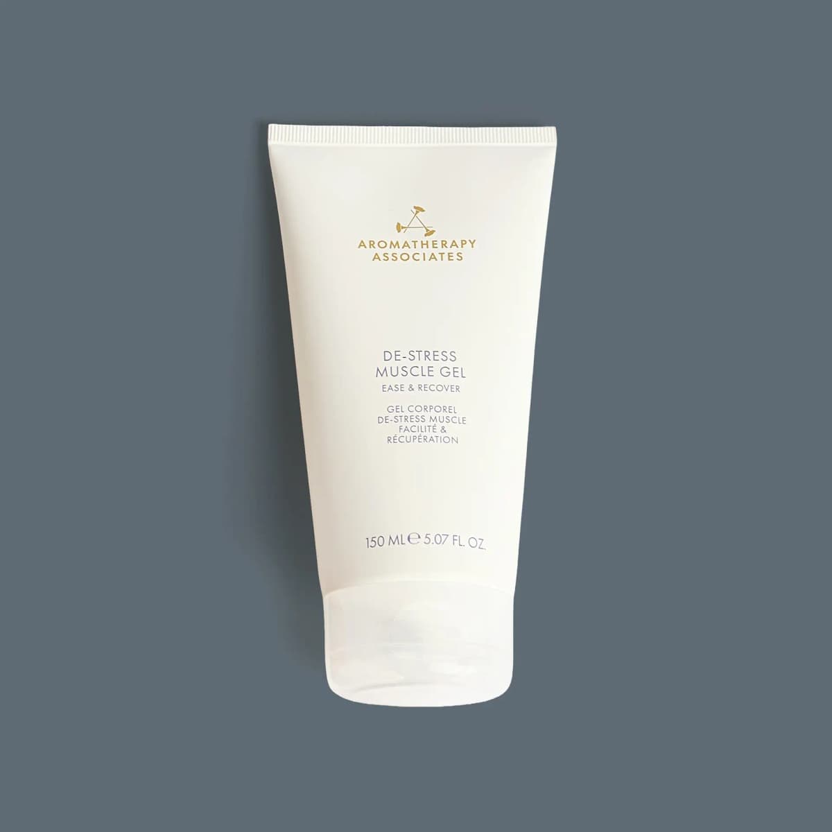 White Aromatherapy Associates De-Stress Muscle Gel 150ml tube with gold logo and clear flip cap on slate grey