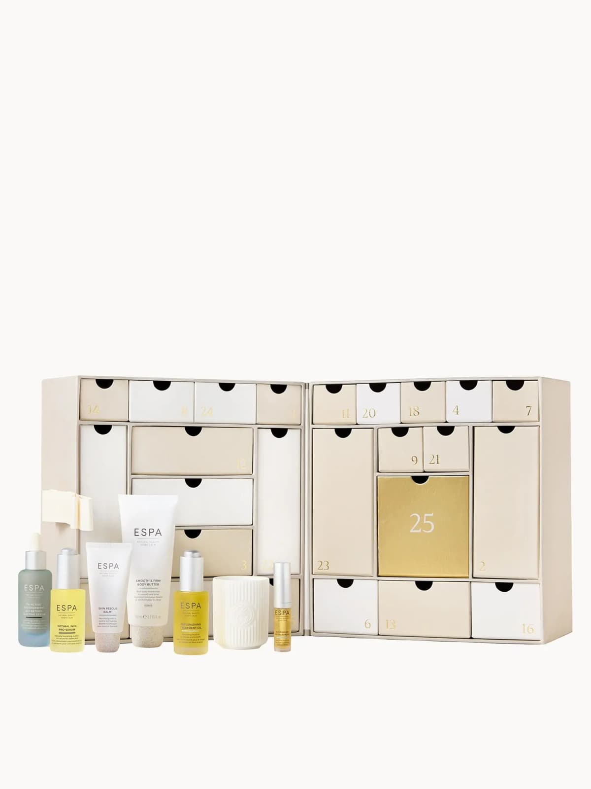 Open beige cabinet with numbered drawers and gold 25 door, serums, tubes, candle and lip oil in front