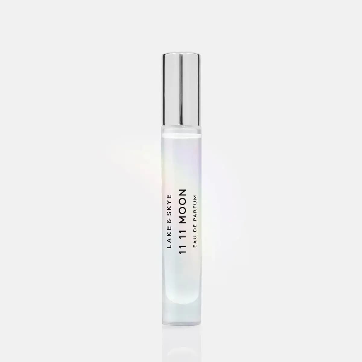 Single 11 11 Moon Eau de Parfum travel spray with silver cap and iridescent frosted glass on a white background.
