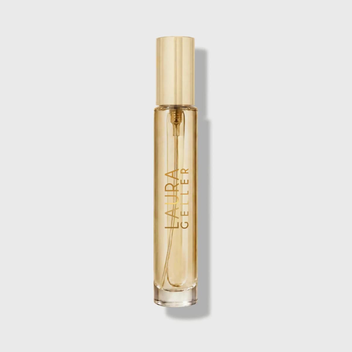 Slim cylindrical Laura Geller travel spray with gold cap and gold vertical logo on pale grey background