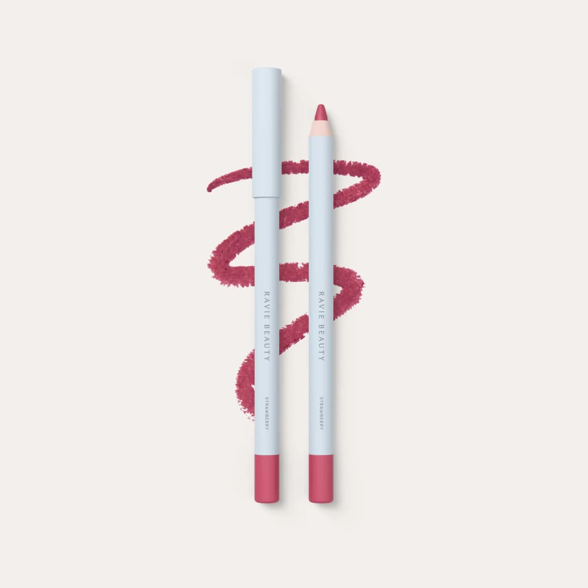 Ravie Beauty lip liner in Strawberry, two light blue pencils with a bright pink zigzag swatch.